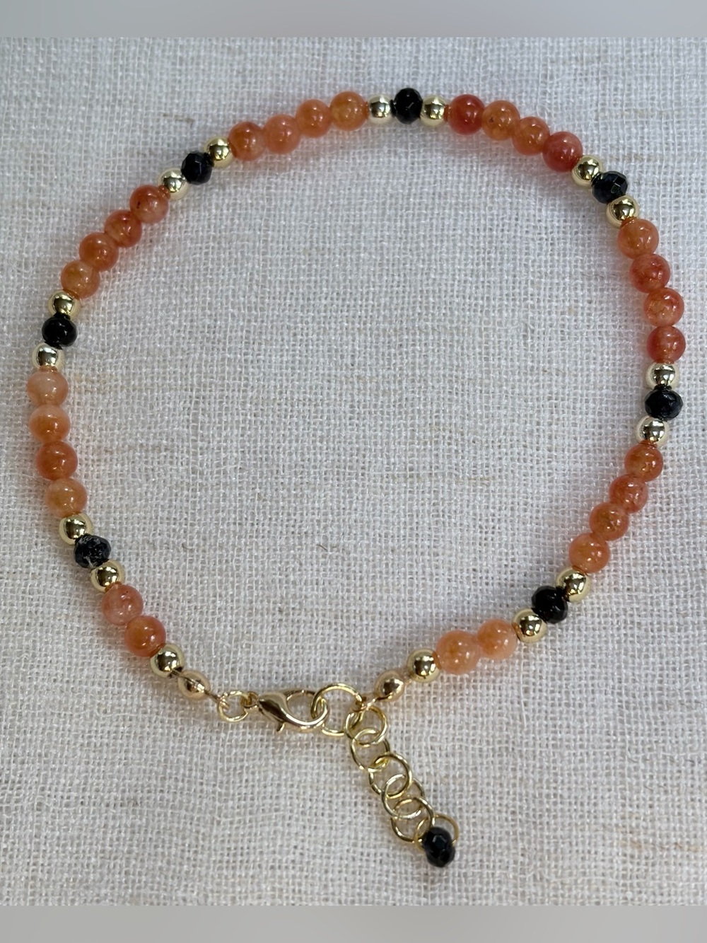 His/hers Bracelet-peach Sunstone,black Onyx,gold plated beads.Vitality,strength.